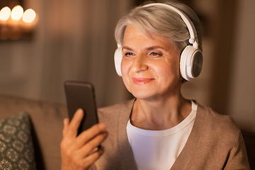 Image showing senior woman in headphones listening to music