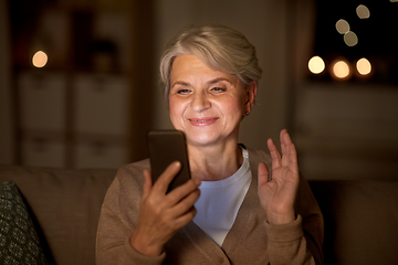 Image showing happy old woman with smartphone having video call