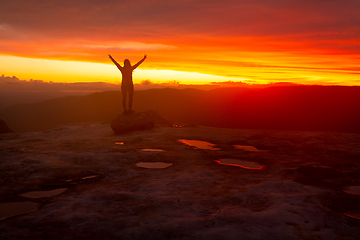 Image showing Woman praise glory success silhouette against red sunset sky