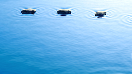 Image showing pebble stones in water with ripples background