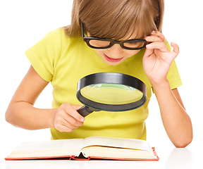 Image showing Little girl is reading book