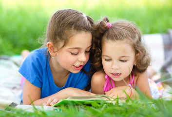 Image showing Two little girls are reading book