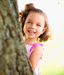 Image showing Cute little girl is playing hide and seek