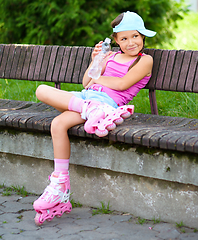 Image showing Little girl is wearing roller-blades