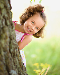 Image showing Cute little girl is playing hide and seek