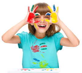 Image showing Portrait of a cute girl playing with paints