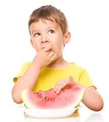 Image showing Little boy is eating watermelon