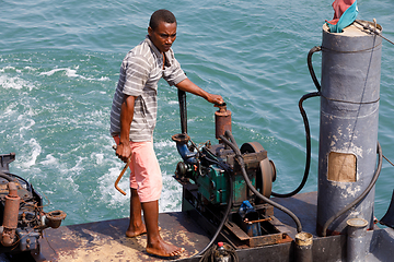Image showing man manages the ship in port of Nosy Be, Madagascar