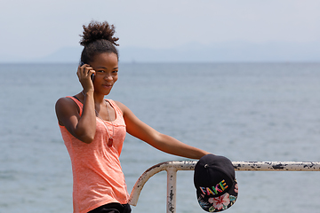 Image showing Malagasy woman take phone calling Nosy Be port, Madagascar