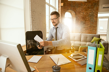 Image showing A young businessman moving in office, getting new work place