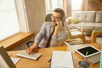 Image showing A young businessman moving in office, getting new work place