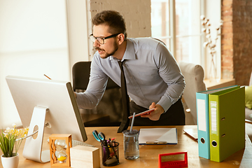 Image showing A young businessman moving in office, getting new work place