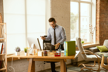 Image showing A young businessman moving in office, getting new work place