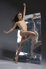 Image showing Young and stylish modern ballet dancer on grey background