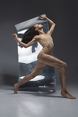 Image showing Young and stylish modern ballet dancer on grey background