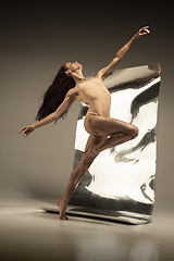 Image showing Young and stylish modern ballet dancer on brown background