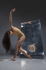 Image showing Young and stylish modern ballet dancer on grey background