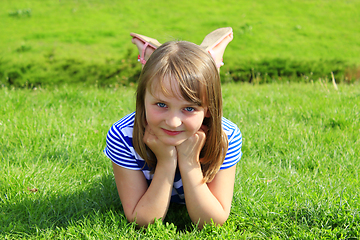 Image showing portrait of little girl lying on the grass