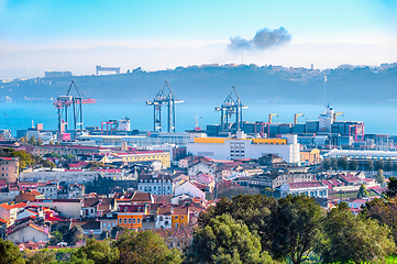 Image showing Lisbon skyline, cranes and cargo containers