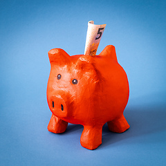 Image showing red papier mache piggy bank with 5 Euros