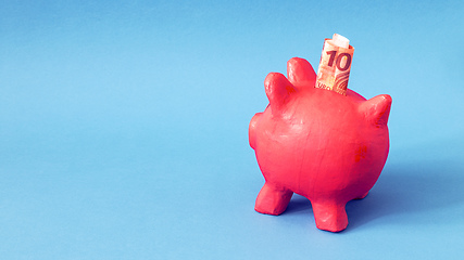 Image showing pink papier mache piggy bank with 10 Euros