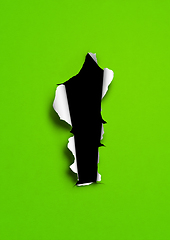 Image showing Green torn paper with black hole