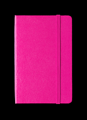 Image showing Magenta pink closed notebook isolated on black