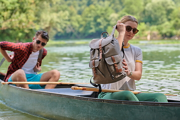 Image showing friends are canoeing in a wild river