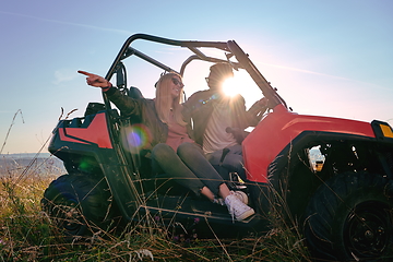 Image showing couple enjoying beautiful sunny day while driving a off road buggy