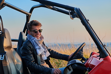 Image showing man enjoying beautiful sunny day while driving a off road buggy car