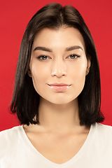 Image showing Caucasian young woman\'s close up portrait on red background