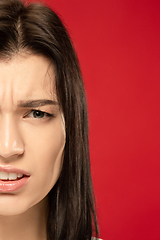 Image showing Caucasian young woman\'s close up portrait on red background