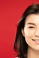 Image showing Caucasian young woman\'s close up portrait on red background