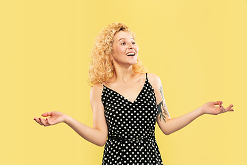 Image showing Caucasian young woman\'s half-length portrait on yellow background