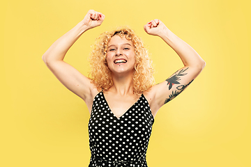 Image showing Caucasian young woman\'s half-length portrait on yellow background