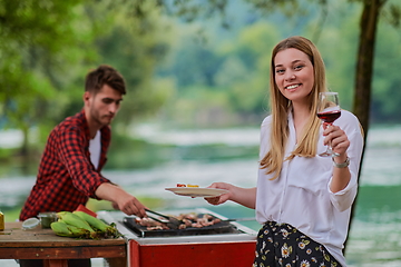 Image showing friends having picnic french dinner party outdoor during summer holiday