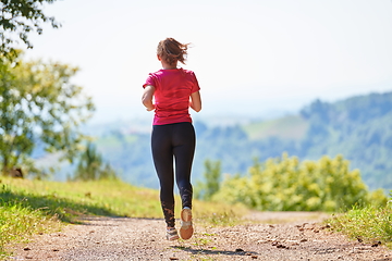 Image showing woman enjoying in a healthy lifestyle while jogging