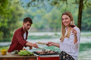 Image showing friends having picnic french dinner party outdoor during summer holiday