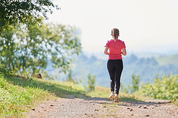 Image showing woman enjoying in a healthy lifestyle while jogging