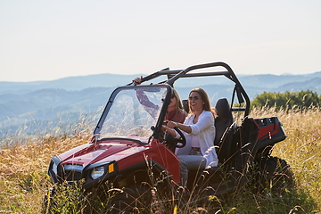 Image showing girls enjoying a beautiful sunny day while driving an off-road car