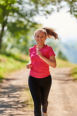 Image showing woman enjoying in a healthy lifestyle while jogging