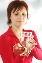 Image showing A woman with an apple