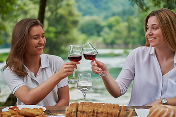 Image showing girlfriends having picnic french dinner party outdoor