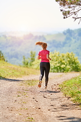 Image showing woman enjoying in a healthy lifestyle while jogging