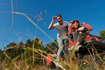 Image showing couple enjoying beautiful sunny day while driving a off road buggy