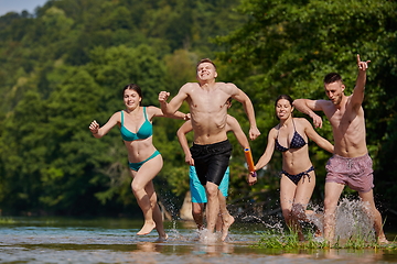 Image showing group of happy friends having fun on river