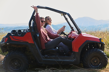 Image showing girls enjoying a beautiful sunny day while driving an off-road car