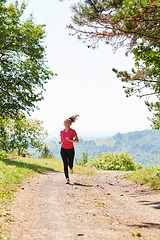 Image showing woman enjoying in a healthy lifestyle while jogging