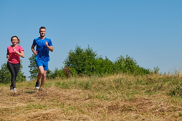 Image showing couple jogging in a healthy lifestyle on a fresh mountain air