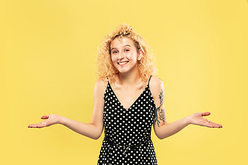 Image showing Caucasian young woman\'s half-length portrait on yellow background